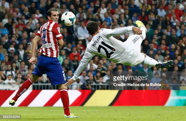 Alvaro Morata of Real Madrid in action against Diego Godín of Atletico de Madrid during the La Liga match between Real Madrid and Club Atletico de...