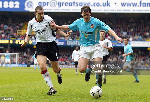 Kevin Kilbane of Sunderland holds off Fulham captain Andy Melville during the FA Barclaycard Premiership match between Fulham and Sunderland at...