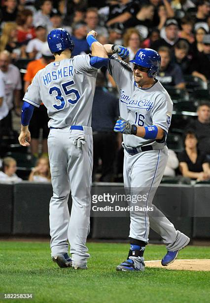 Billy Butler of the Kansas City Royals is greeted by Eric Hosmer after hitting a two-run homer against the Chicago White Sox during the sixth inning...