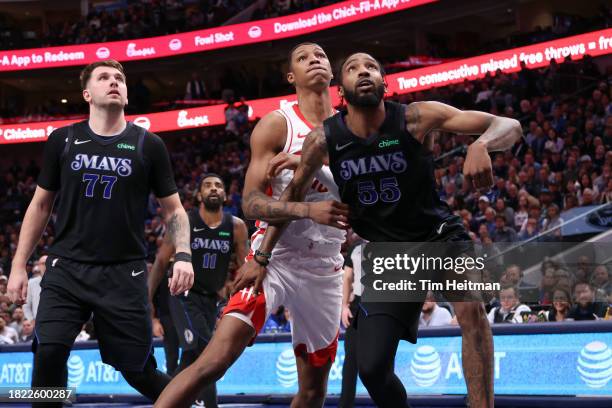 Luka Doncic of the Dallas Mavericks and Derrick Jones Jr. #55 of the Dallas Mavericks fight for a rebound against Jabari Smith Jr. #10 of the Houston...