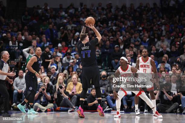 Luka Doncic of the Dallas Mavericks shoots the ball against Aaron Holiday of the Houston Rockets in the second half during an NBA In-Season...