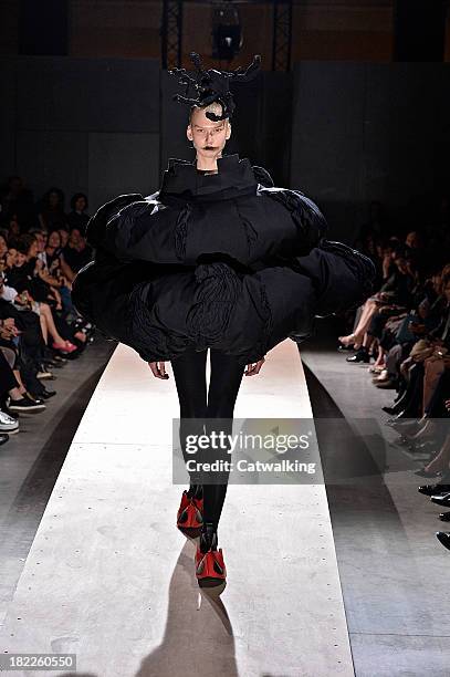 Model walks the runway at the Comme des Garcons Spring Summer 2014 fashion show during Paris Fashion Week on September 28, 2013 in Paris, France.