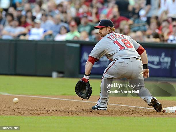 Chad Tracy of the Washington Nationals makes a play on a ball in the dirt while covering first base against the Arizona Diamondbacks at Chase Field...