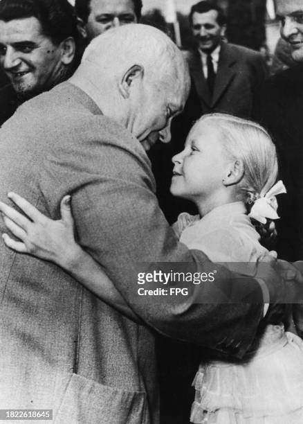 Russian politician Nikita Khrushchev , First Secretary of the Communist Party of the Soviet Union, embracing a young girl during a visit to Plzeň ,...
