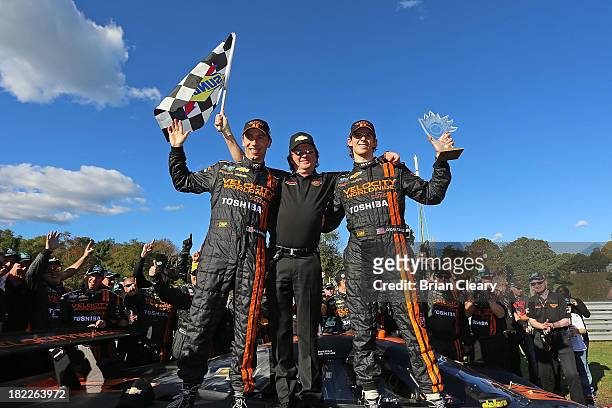 Wayne Taylor celebrates with his son Jordan Taylor and Max Angelelli of Italy after they won the Grand-Am Rolex Series race and clinched the season...