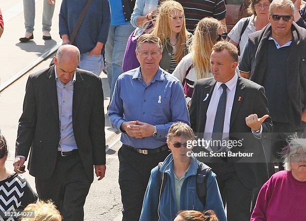 Victorian Premier Denis Napthine walks along Sydney Road in Brunswick in a peace march to mark the first anniversary of the murder of Jill Meagher on...