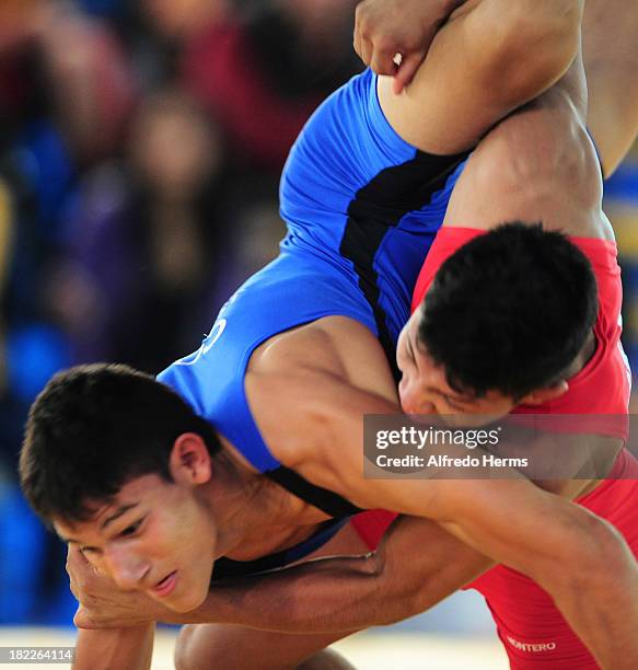 Sanchez of Colombia and A. Montero of Venezuela compete in Greco Roman 63kg as part of the I ODESUR South American Youth Games at Polideportivo Villa...