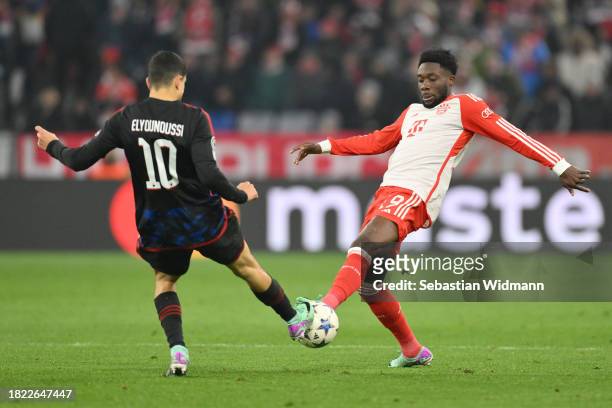 Mohamed Elyounoussi of F.C. Copenhagen and Alphonso Davies of FC Bayern München compete for the ball during the UEFA Champions League match between...