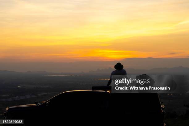 people sitting on a car during sunset - car waxing stock pictures, royalty-free photos & images