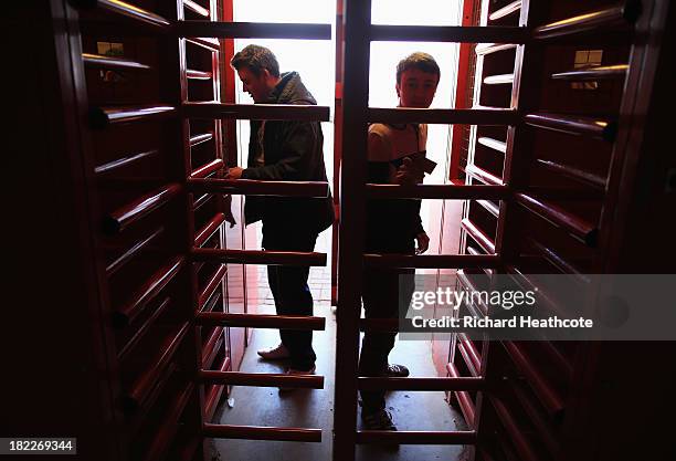 Supporters enter the ground through the turnstiles prior to the Barclays Premier League match between Stoke City and Norwich City at the Britannia...