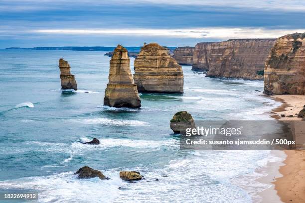 scenic view of rocks in sea against sky,apostle neart port campbell,victoria,australia - neart stock pictures, royalty-free photos & images