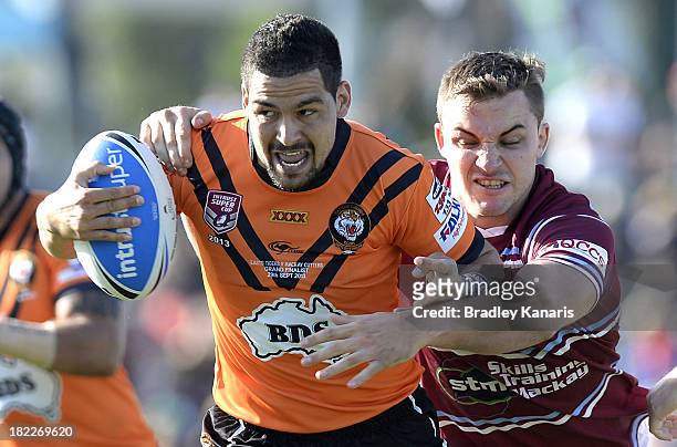 Cody Walker of the Tigers takes on the defence during the 2013 QLD Cup Grand Final match between the Easts Tigers and Mackay Cutters at Suncorp...