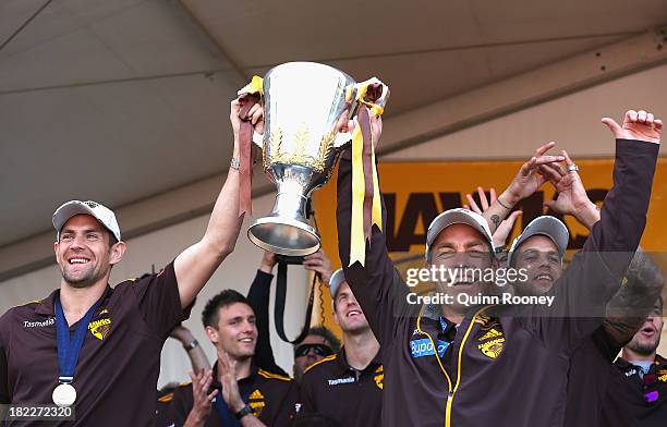 Alastair Clarkson the coach and Luke Hodge the captain of the Hawks show the Premiership Cup to the crowd during the Hawthorn Hawks Fan Day at...