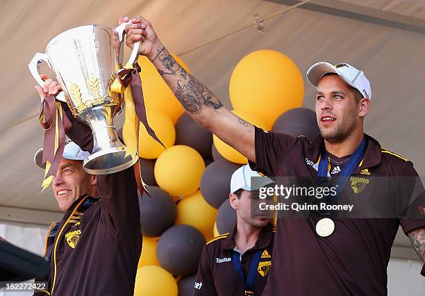 Alastair Clarkson the coach of the Hawks and Lance Franklin of the Hawks show the Premiership Cup to the crowd during the Hawthorn Hawks Fan Day at...