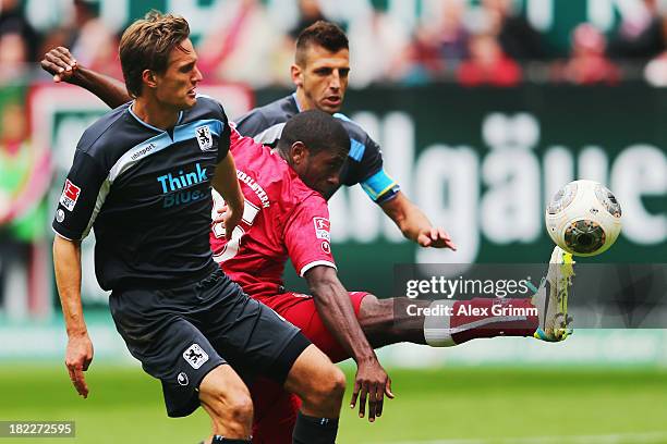 Olivier Occean of Kaiserslautern is challenged by Kai Buelow and Guillermo Vallori of Muenchen during the Second Bundesliga match between 1. FC...