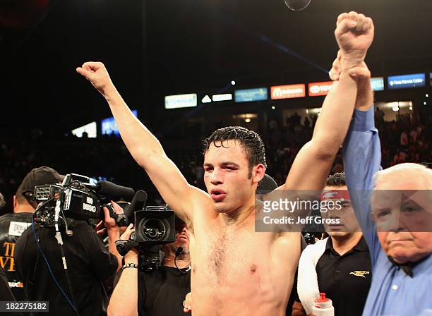 Julio Cesar Chavez Jr. Celebrates his Light Heavyweight bout victory over Brian Vera next to referee Lou Moret at StubHub Center on September 28,...