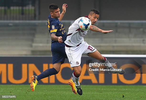 Federico Ceccherini of AS Livorno competes for the ball with Arevalos Juan Manuel Iturbe of Hellas Verona FC during the Serie A match between Hellas...