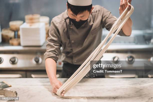 chef making hand pulled noodles - noodles stock pictures, royalty-free photos & images