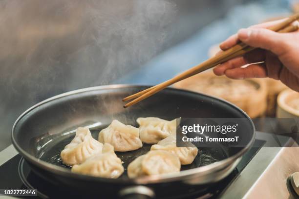 close-up of dumplings being fryed - dim sum meal stock pictures, royalty-free photos & images