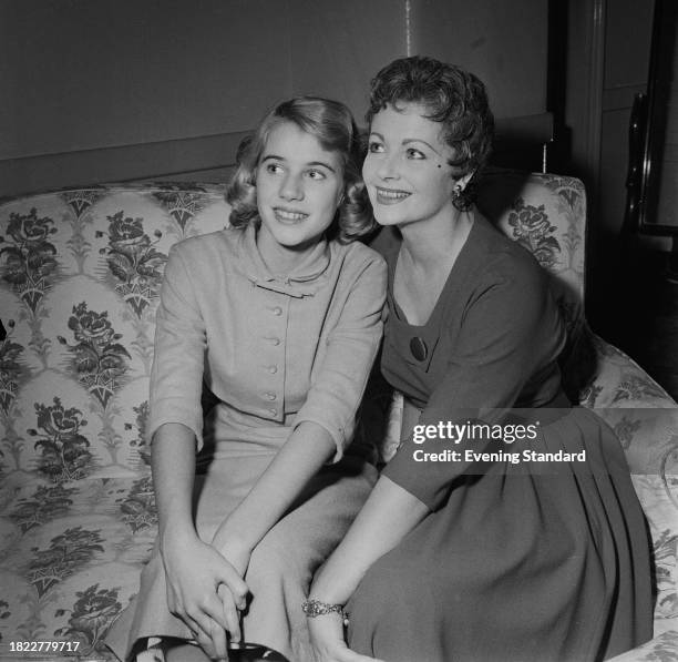 Actress Julia Lockwood with her mother, actress Margaret Lockwood seated together on a sofa, November 12th 1957.