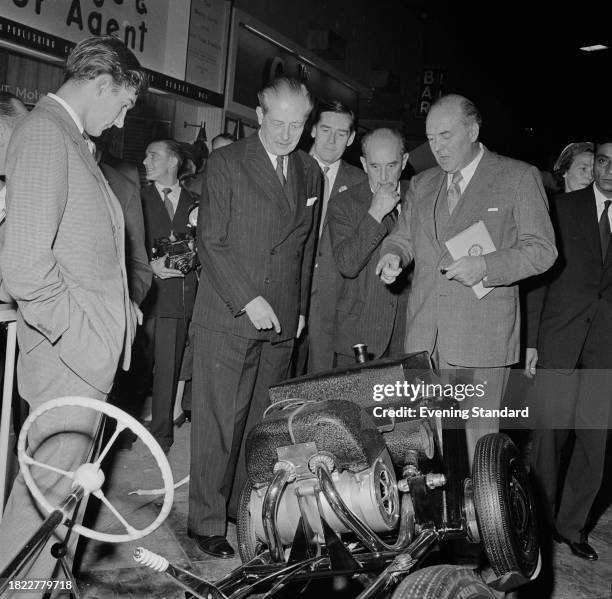 Prime Minister Harold Macmillan looks at the chassis of a Frisky sports car at the London Motor Show, Earl's Court, London, October 15th 1957.