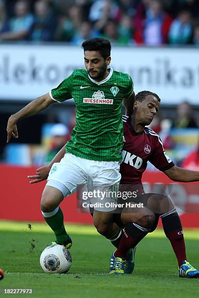 Mehmet Ekici of Bremen and Timothy Chandler of Nuernberg compete for the ball during the First Bundesliga match between SV Werder Bremen and 1.FC...