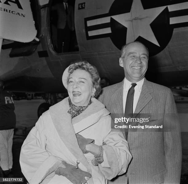 American actress Jessie Royce Landis with her husband, Major General John FR Seitz in front of a Pan American Airways plane, November 14th 1957.