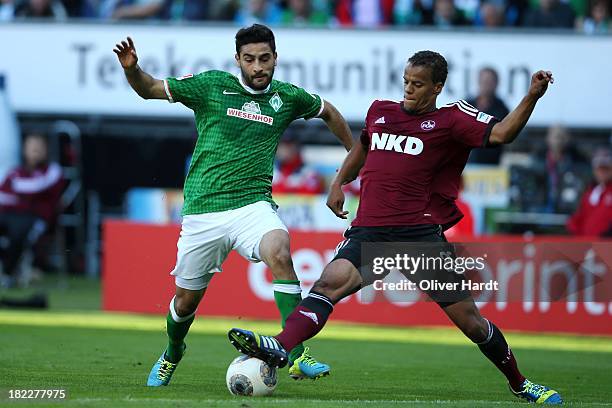Mehmet Ekici of Bremen and Timothy Chandler of Nuernberg compete for the ball during the First Bundesliga match between SV Werder Bremen and 1.FC...