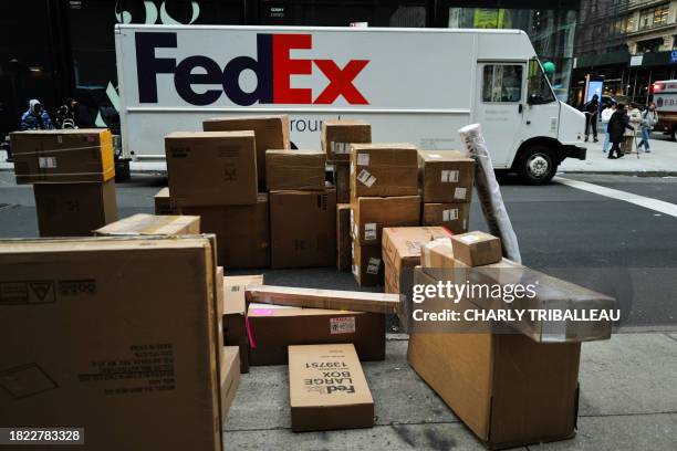 Parcels are seen in a street nearby a FedEx truck in a street of the Manhattan borough in New York City on December 4, 2023.