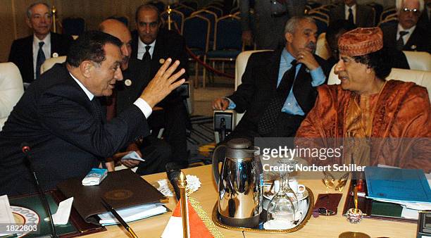 Egyptian President Hosni Mubarak speaks with Libyan Leader Moammar Ghadafi during a break at the Arab summit March 1, 2003 in Sharm el-Sheikh, Egypt....