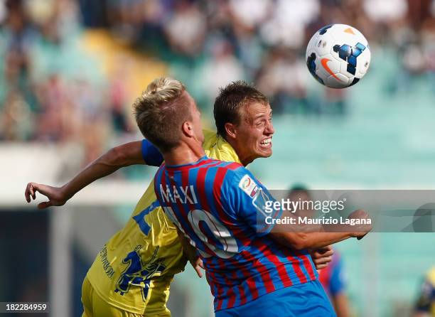 Maxi Lopez of Catania competes for the ball with Alessandro Bernardini of Chievo during the Serie A match between Calcio Catania and AC Chievo Verona...