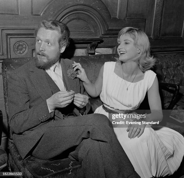 Actors Patrick McGoohan and Jill Ireland sitting on a sofa, October 10th 1957.
