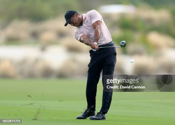 Tiger Woods of The United States plays his second shot on the third hole during the first round of the Hero World Challenge at Albany Golf Course on...