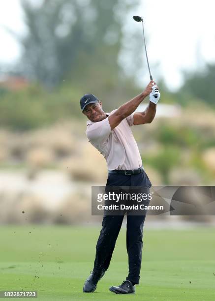Tiger Woods of The United States plays his second shot on the third hole during the first round of the Hero World Challenge at Albany Golf Course on...