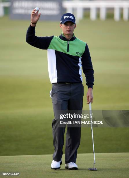 English golfer Tom Lewis gestures as he finishes his round during the final day of The Alfred Dunhill Links Championships golf competition on The Old...