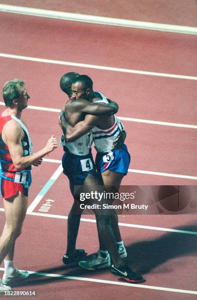 Allen Johnson of the USA embracing Colin Jackson of Great Britain with Igor Kovac of Slovenia who finished 3rd after winning the Men's 110m hurdles...