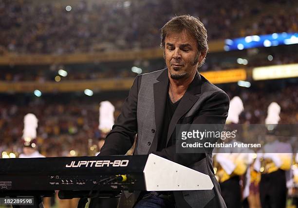 Jonathan Cain of Journey perform the National Anthem before the college football game between the Arizona State Sun Devils and the USC Trojans at Sun...