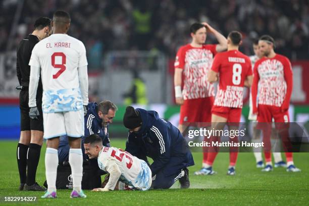 Daniel Podence of Olympiacos receives medical treatment during the UEFA Europa League match between Sport-Club Freiburg and Olympiacos FC at...