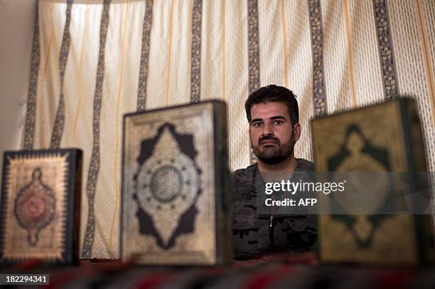 Picture dated September 18, 2013 shows Abu Ammar, whose brigade is one of the most powerful rebel groups in Syria, posing during an interview with a...