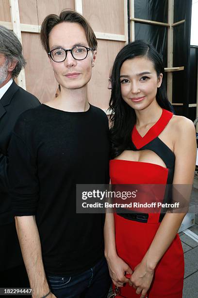 Fashion designer Maxime Simoens and Xing Tong Yaho after Maxime Simoens show as part of the Paris Fashion Week Womenswear Spring/Summer 2014, held at...