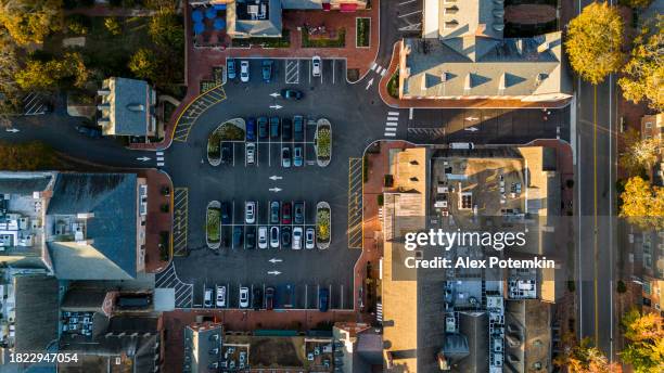 parking lots and rooftops of historical brick houses of merchants square in colonial williamsburg in virginia. top aerial view - williamsburg virginia stock pictures, royalty-free photos & images