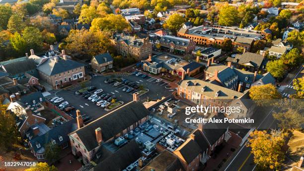 parking lots and colonial row houses in historical touristic center of colonial williamsburg, virginia at sunset - colonial williamsburg stock pictures, royalty-free photos & images