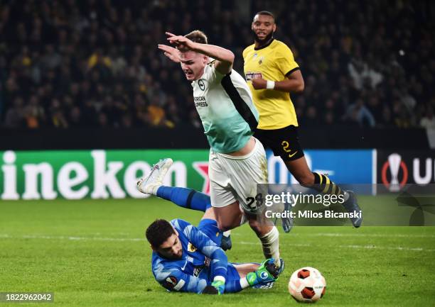 Evan Ferguson of Brighton & Hove Albion is challenged in the box by Cican Stankovic of AEK Athens during the UEFA Europa League 2023/24 match betweek...