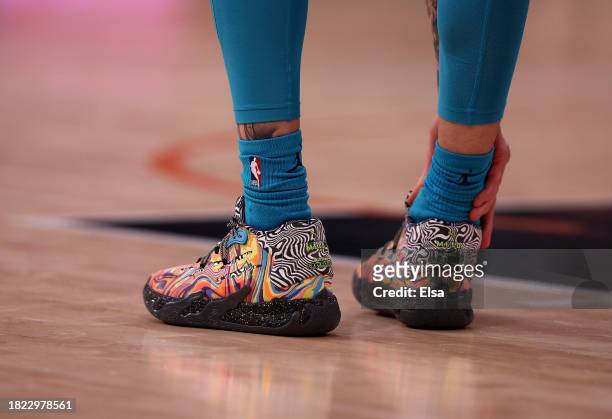 The shoes of LaMelo Ball of the Charlotte Hornets are seen as he grabs his ankel after a play during the first half against the New York Knicks at...