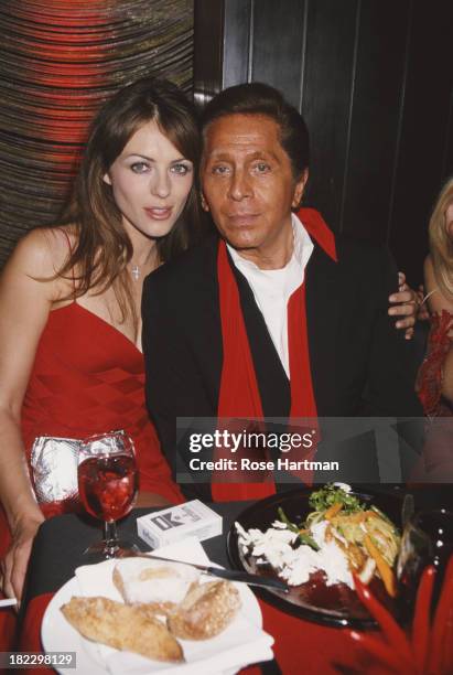 English model and actress Elizabeth Hurley with Italian fashion designer Valentino Garavani at the Four Seasons Restaurant, New York City, circa 1997.