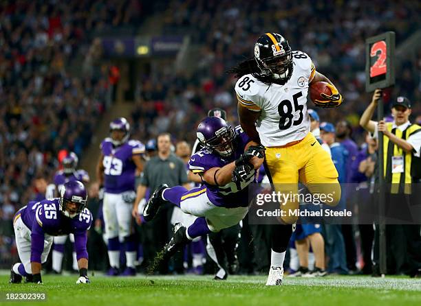 Tight end David Johnson of the Pittsburgh Steelers is tackled by outside linebacker Chad Greenway of the Minnesota Vikings during the NFL...