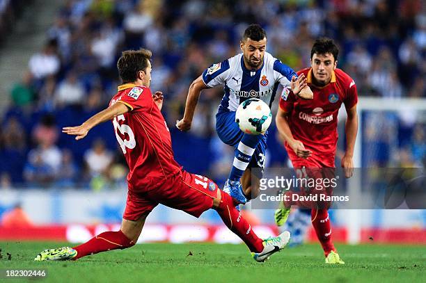 Simao Sabrosa of RCD Espanyol duels for the ball with Rafael Lopez and Michel Madera of Getafe CF during the La Liga match between RCD Espanyol and...