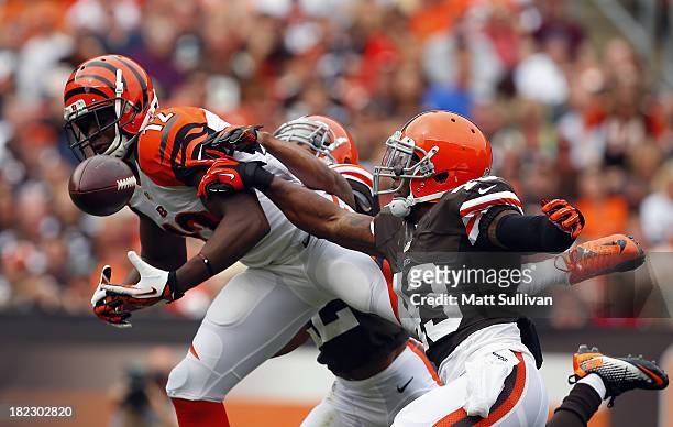 Wide receiver Mohamed Sanu of the Cincinnati Bengals has a pass knocked away by defensive backs Buster Skrine and T.J. Ward of the Cleveland Browns...