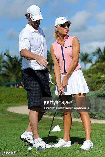 Slade Smiley and Gretchen Rossi attend the Golf Clinic with Greg Norman and Golf Tournament during Day Three of the Sandals Emerald Bay Celebrity...