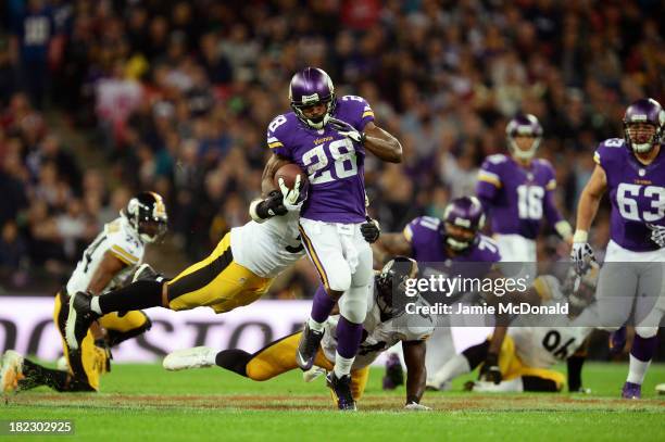 Running back Adrian Peterson of the Minnesota Vikings beats outside linebacker LaMarr Woodley of the Pittsburgh Steelers and inside linebacker...